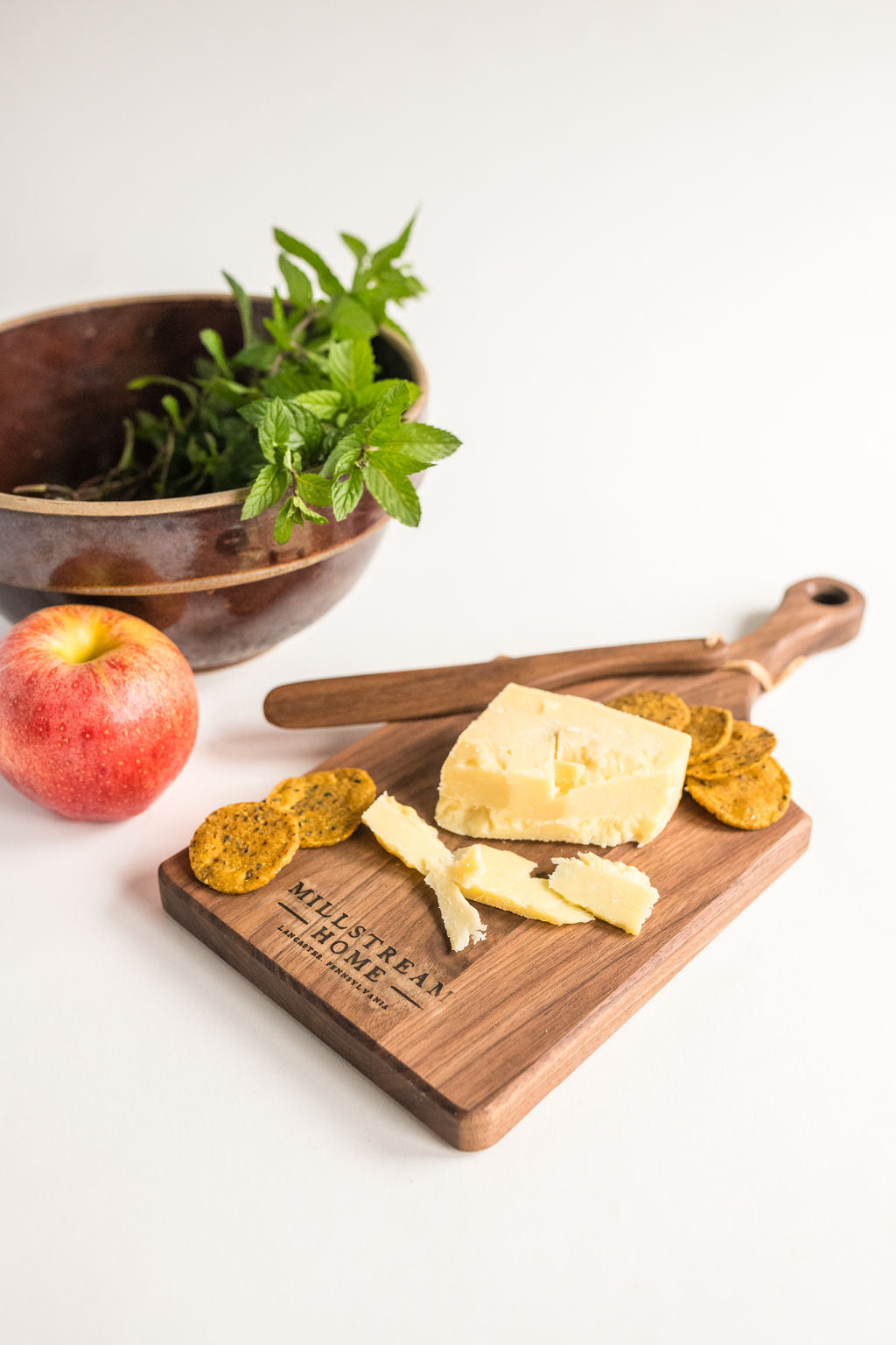 Walnut Cheese Board with Cheese and Crackers on Top
