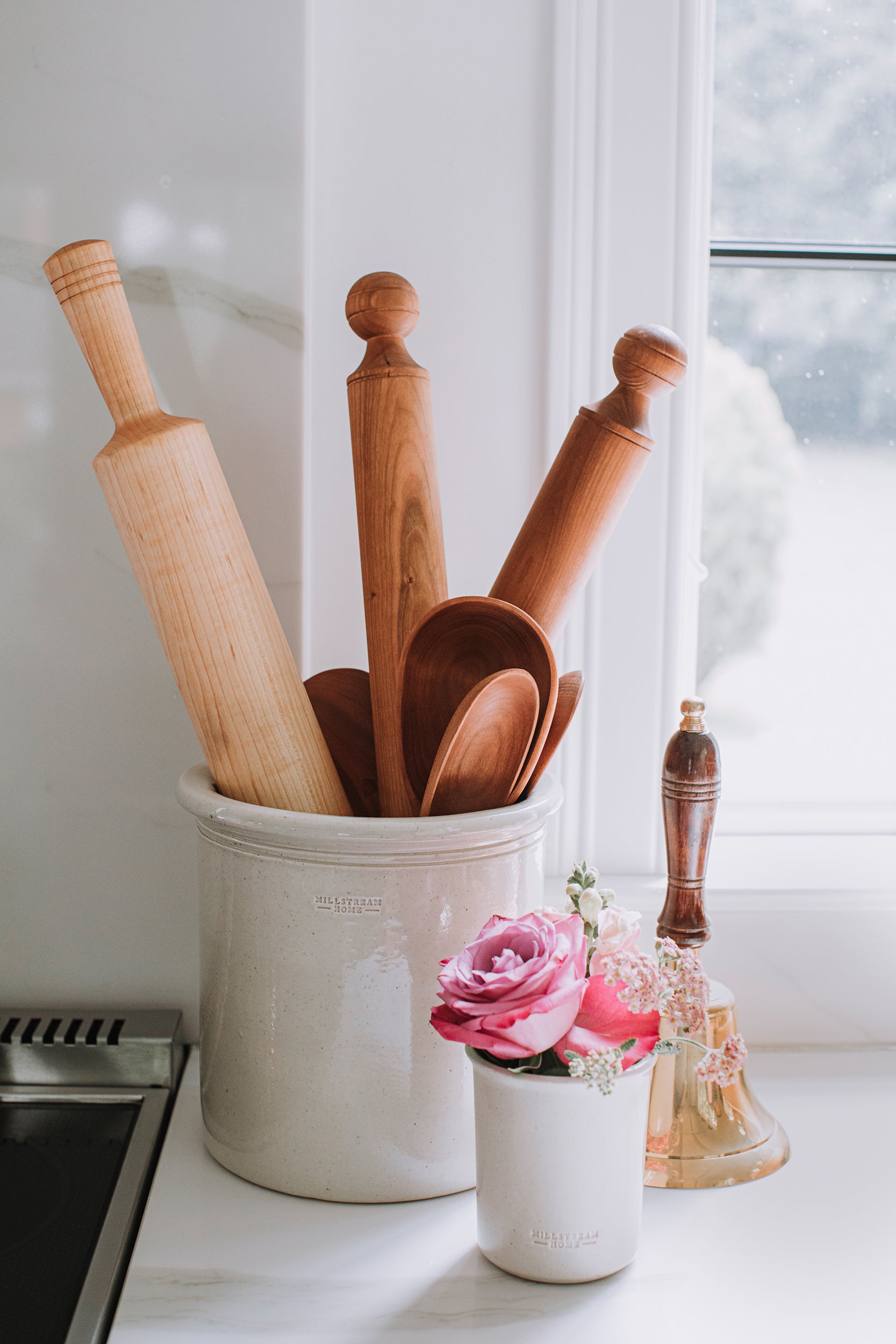 The Classic Rolling Pin in a Crock on a Countertop