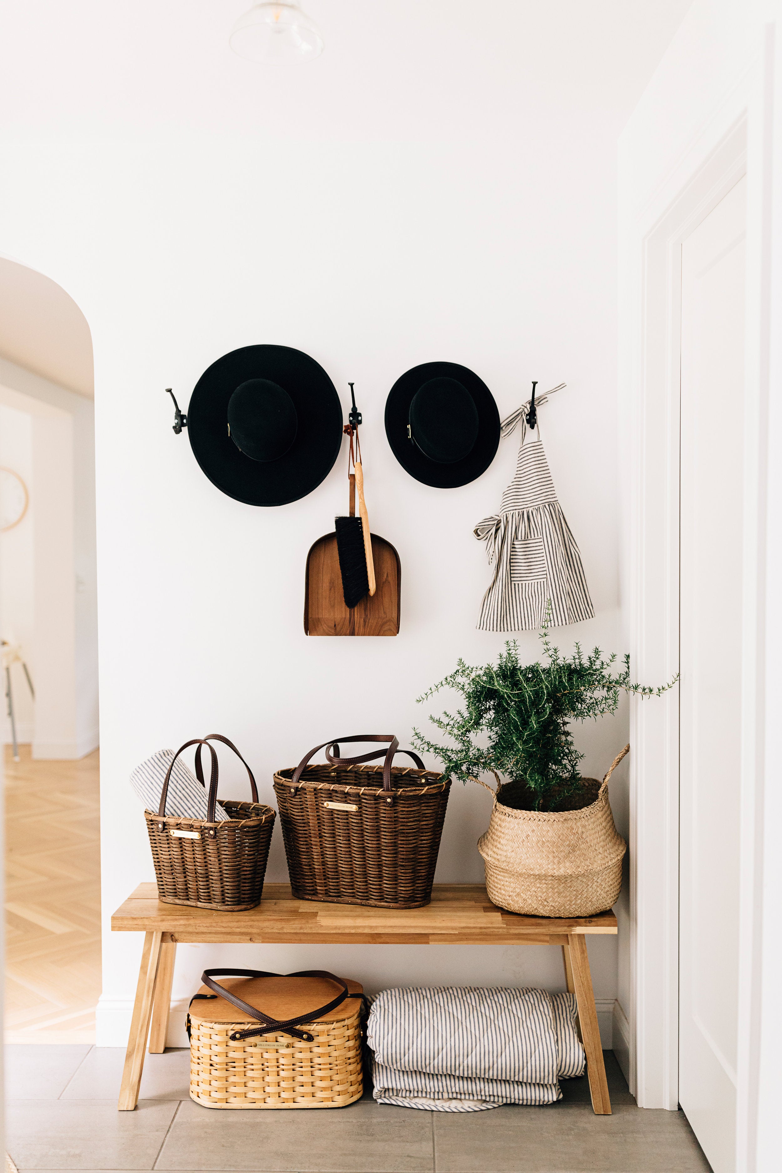 Two Child's Black Saddle Hats Hanging on a Wall