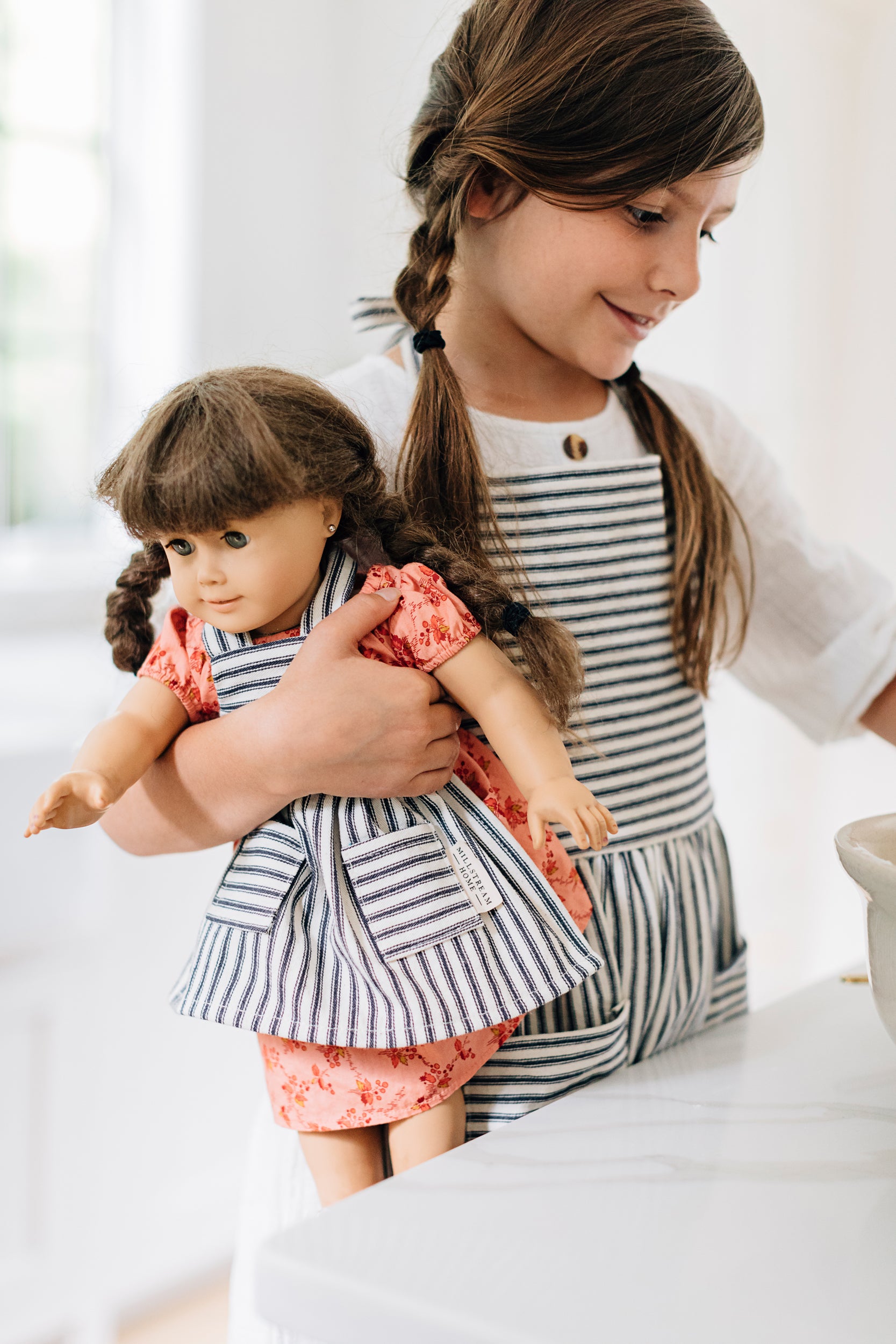 Child and Doll Wearing Matching Aprons