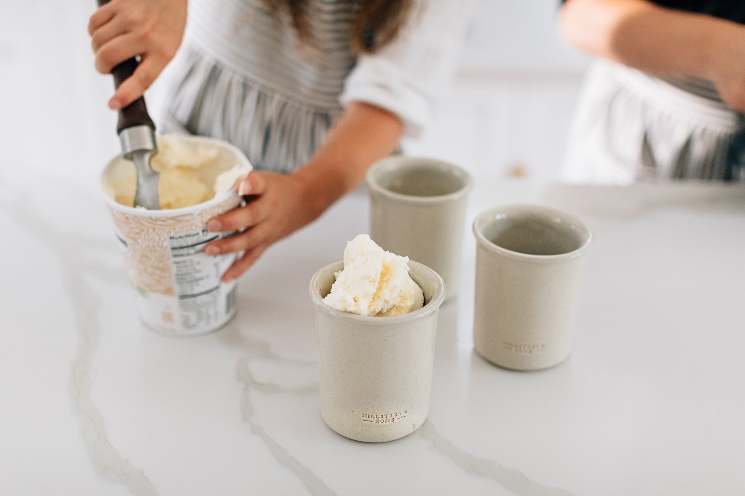 Scooping Ice Cream into a Millstream Home Cup